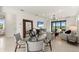 Open concept living space boasts dining area, living room, and sliding glass doors at 10463 Abaco Falls Dr, Englewood, FL 34223