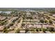 From the air, see the home's position within a community near a lake and commercial area for convenient living at 1051 Pert Ln, Holiday, FL 34691