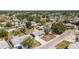 A beautiful aerial view showcases this single-Gathering home's neighborhood and mature trees offering a serene setting at 1051 Pert Ln, Holiday, FL 34691