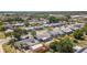 The aerial view captures the home nestled in a neighborhood with tree-lined streets and a variety of home styles at 1051 Pert Ln, Holiday, FL 34691