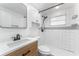 Modern bathroom features updated shower and vanity and a neutral color scheme at 1051 Pert Ln, Holiday, FL 34691