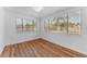 The bedroom has laminate flooring and two windows that provide ample natural light at 1051 Pert Ln, Holiday, FL 34691