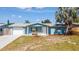 Charming single-story home with blue siding, white trim, and a well-maintained front yard at 1051 Pert Ln, Holiday, FL 34691