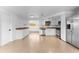 This spacious kitchen boasts white cabinets, stainless steel appliances, and tile floors at 1051 Pert Ln, Holiday, FL 34691