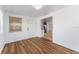 Bright living room with wood flooring, and an open flow to kitchen area is move-in ready at 1051 Pert Ln, Holiday, FL 34691