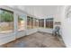 Light-filled sunroom with tile flooring and plenty of windows overlooking the backyard at 1051 Pert Ln, Holiday, FL 34691