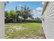 Grassy backyard showing a small swing set and partial fence view at 109 Emerald Ln, Largo, FL 33771