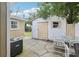 The backyard has a detached shed with chairs, a table, and a grill for outdoor enjoyment at 109 Emerald Ln, Largo, FL 33771