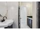 Half bath with a pedestal sink and a view into the full bathroom at 109 Emerald Ln, Largo, FL 33771