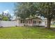 Charming home featuring a lush front lawn and mature trees at 109 Emerald Ln, Largo, FL 33771