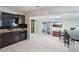 Modern kitchen with dark countertops, cabinets, tile floors, stainless steel appliances, and sliding doors at 109 Emerald Ln, Largo, FL 33771