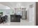 Bright kitchen with a black tile breakfast bar, stainless steel appliances, and tile flooring at 109 Emerald Ln, Largo, FL 33771