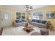 Bright and airy living room with neutral tones, comfortable seating, and large windows at 109 Emerald Ln, Largo, FL 33771