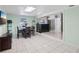 Open-concept living area with tile floors, a dining table, and great views of the bar and entrance at 109 Emerald Ln, Largo, FL 33771