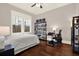 This bedroom has hardwood floors, a ceiling fan, and large windows that provide great natural light at 111 E Jean St, Tampa, FL 33604