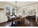 Open dining area with wood floors, a modern light fixture and easy access to the living room at 111 E Jean St, Tampa, FL 33604