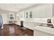 Bright kitchen features white cabinets, stainless steel appliances, and dark wood floors at 111 E Jean St, Tampa, FL 33604