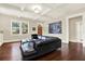 Bright living room featuring hardwood floors, a coffered ceiling, and a comfortable black leather sofa at 111 E Jean St, Tampa, FL 33604