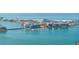 Beautiful waterfront property showcasing waterfront living with docks and boats, and beach views on the horizon at 11160 8Th E St, Treasure Island, FL 33706