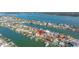 An aerial shot showing the home's location along a waterfront with dock, marked with a red location pin at 11160 8Th E St, Treasure Island, FL 33706