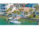Aerial view of a waterfront home with a private dock, swimming pool, and lush landscaping, perfect for boating enthusiasts at 11160 8Th E St, Treasure Island, FL 33706