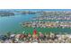 Aerial view of waterfront property, highlighting its prime location and proximity to the bay and beach at 11160 8Th E St, Treasure Island, FL 33706