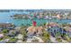 Aerial view of waterfront property with lush landscaping, multiple car driveway, and convenient access to open water at 11160 8Th E St, Treasure Island, FL 33706