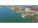 Aerial view of waterfront home with a dock, boat, and in-ground pool at 11160 8Th E St, Treasure Island, FL 33706