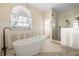 A bathroom with a soaking tub and an adjoining walk-in shower at 11160 8Th E St, Treasure Island, FL 33706