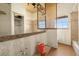 Bathroom featuring wood-paneled ceiling, decorative screen, and large mirror at 11160 8Th E St, Treasure Island, FL 33706