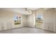 Light-filled bedroom with large windows and ceiling fan at 11160 8Th E St, Treasure Island, FL 33706