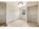 Bright bedroom with a ceiling fan, closet, and single window overlooking tropical palm trees at 11160 8Th E St, Treasure Island, FL 33706