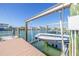 Boat lift with a small boat on the dock, offering easy access to waterfront adventures at 11160 8Th E St, Treasure Island, FL 33706
