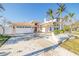 Beautiful home exterior with manicured lawn, paved driveway, and attached garage at 11160 8Th E St, Treasure Island, FL 33706