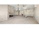 Spacious living room with stone fireplace and modern chandelier at 11160 8Th E St, Treasure Island, FL 33706