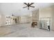 Unfinished living room with a stone fireplace, ceiling fans, and potential for renovation, allowing for personalized design choices at 11160 8Th E St, Treasure Island, FL 33706