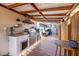 Covered outdoor kitchen with grilling area and small table at 11160 8Th E St, Treasure Island, FL 33706
