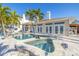 Back exterior featuring a pool, spa and backyard under a clear blue sky at 11160 8Th E St, Treasure Island, FL 33706