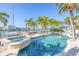 Backyard pool with a jacuzzi, dock, patio with lounge chairs and waterfront views at 11160 8Th E St, Treasure Island, FL 33706