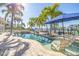 Inviting backyard pool area surrounded by lush palm trees, with waterfront access and comfortable lounge chairs at 11160 8Th E St, Treasure Island, FL 33706
