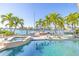 Pool and spa area with a waterfront view of the docks and nearby houses at 11160 8Th E St, Treasure Island, FL 33706