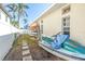 Side yard with paver pathway, surfboard rack, and jet ski along exterior wall at 11160 8Th E St, Treasure Island, FL 33706