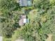 Aerial view of a home with a screened pool surrounded by lush greenery at 11307 Sandpine Rd, Riverview, FL 33569