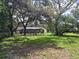 Large backyard with mature trees, swing set, screened pool and patio at 11307 Sandpine Rd, Riverview, FL 33569