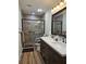 Bathroom with double sink vanity, tile floors and tiled walk-in shower at 11307 Sandpine Rd, Riverview, FL 33569
