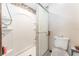 Bathroom showcasing a shower with glass doors, neutral walls, and a nearby toilet at 11307 Sandpine Rd, Riverview, FL 33569