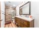 Updated bathroom with dual vanity, wood cabinets, and tiled shower at 11307 Sandpine Rd, Riverview, FL 33569