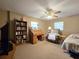 Comfortable bedroom features chair, desk, bookshelf and ceiling fan at 11307 Sandpine Rd, Riverview, FL 33569