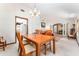 Cozy dining room featuring a wooden dining set, carpeted floors, and natural light from the window at 11307 Sandpine Rd, Riverview, FL 33569