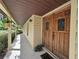 Covered entryway featuring a beautiful wood double door and shade plantings at 11307 Sandpine Rd, Riverview, FL 33569